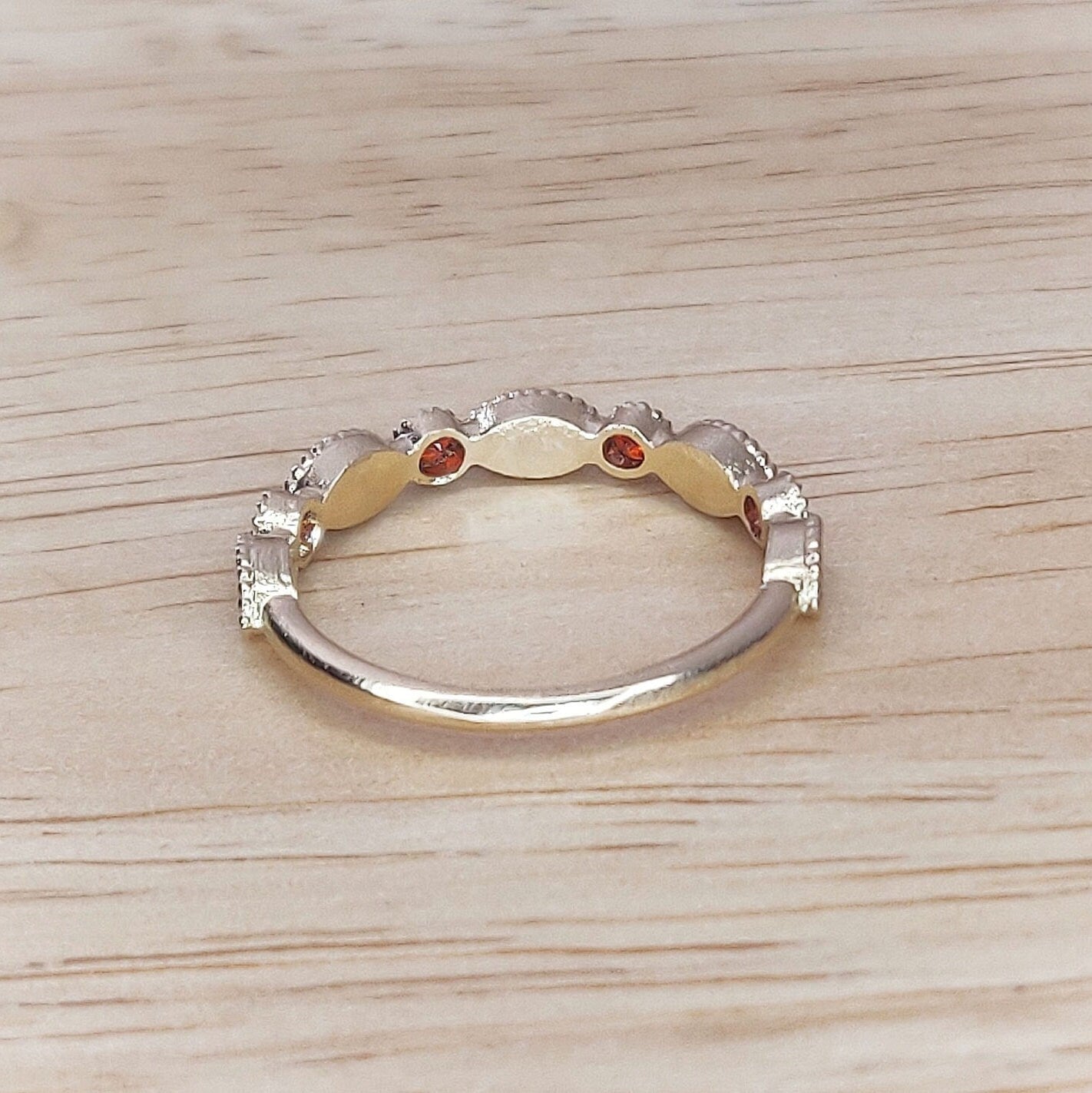 Gold birthstone eternity ring shown from the rear.