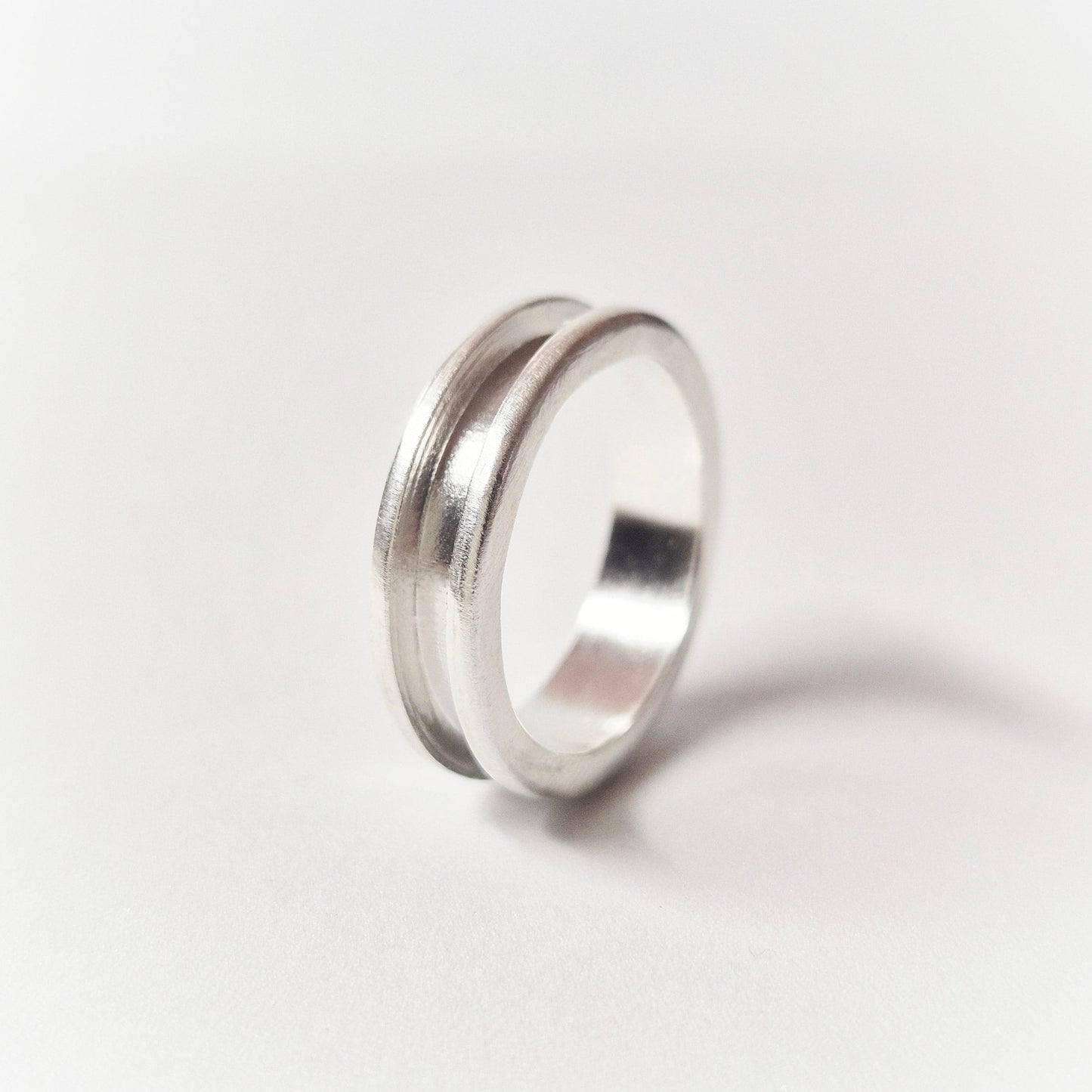 Silver Channel Ring on a White Background