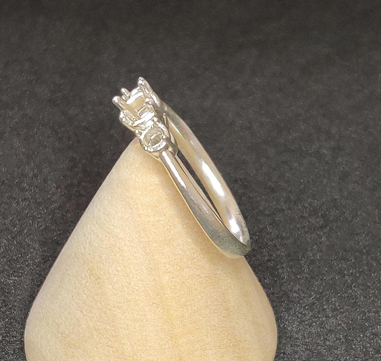 Side view of silver ring blank for prong settings on a cone.