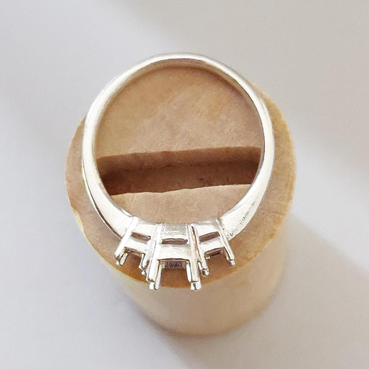 Top view of a silver ring blank for setting of square stones.
