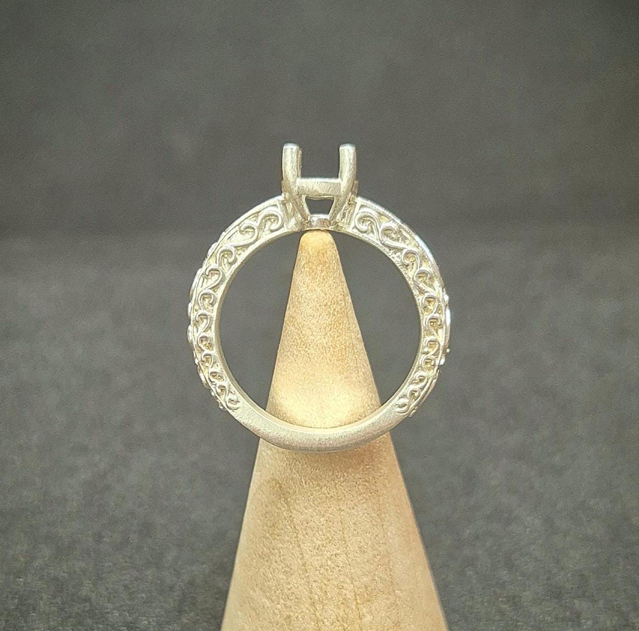 Through finger view of a silver antique style ring.