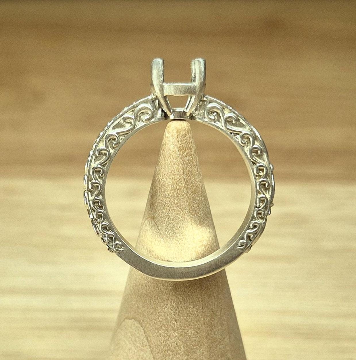 Ornate silver vintage style ring on a display cone.