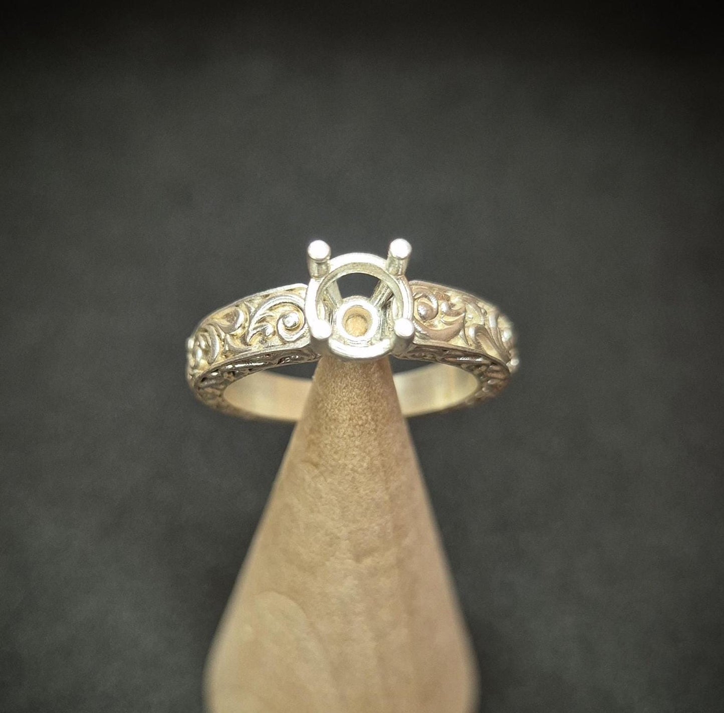 Top view of round gem setting on an antique styled silver ring.