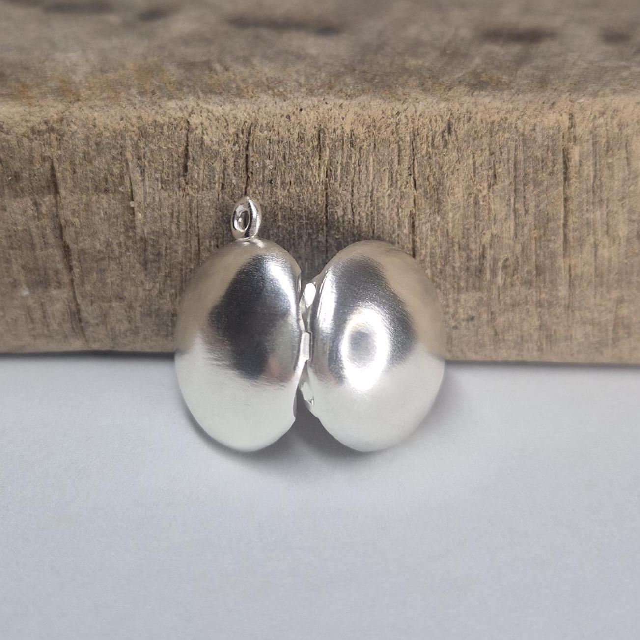 Rear View of an Open Round Silver Locket.