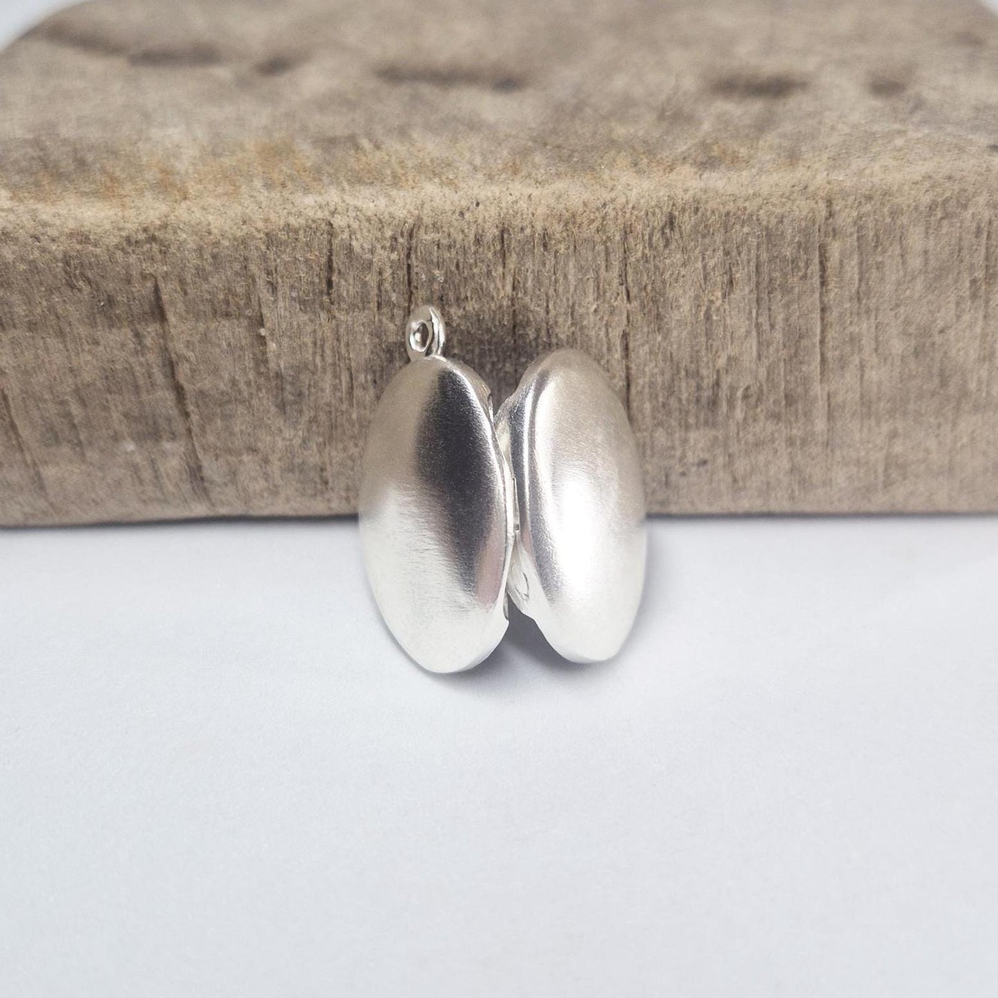 Rear View of an Open Oval Silver Locket.