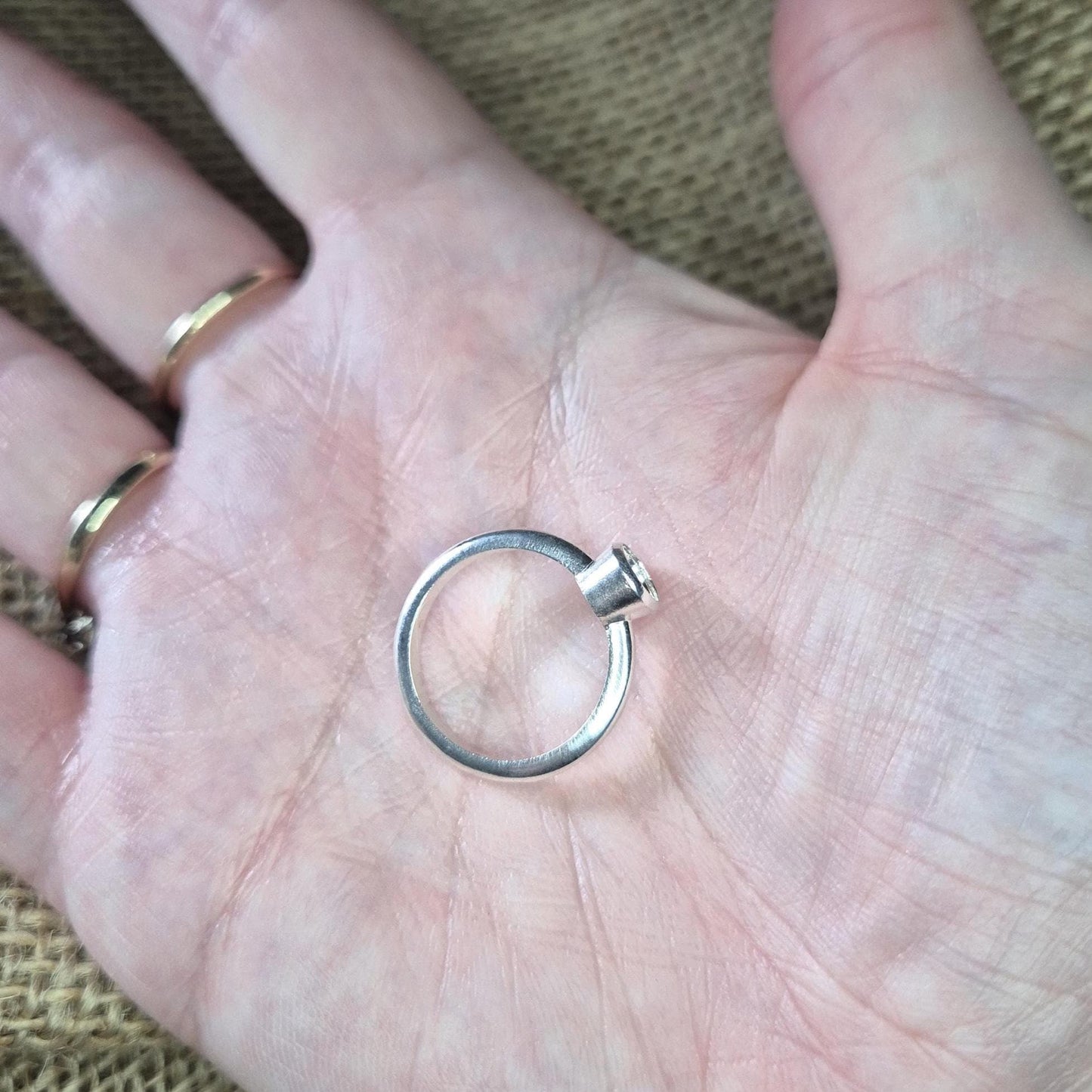 Silver Bezel Ring in a Hand for Scale