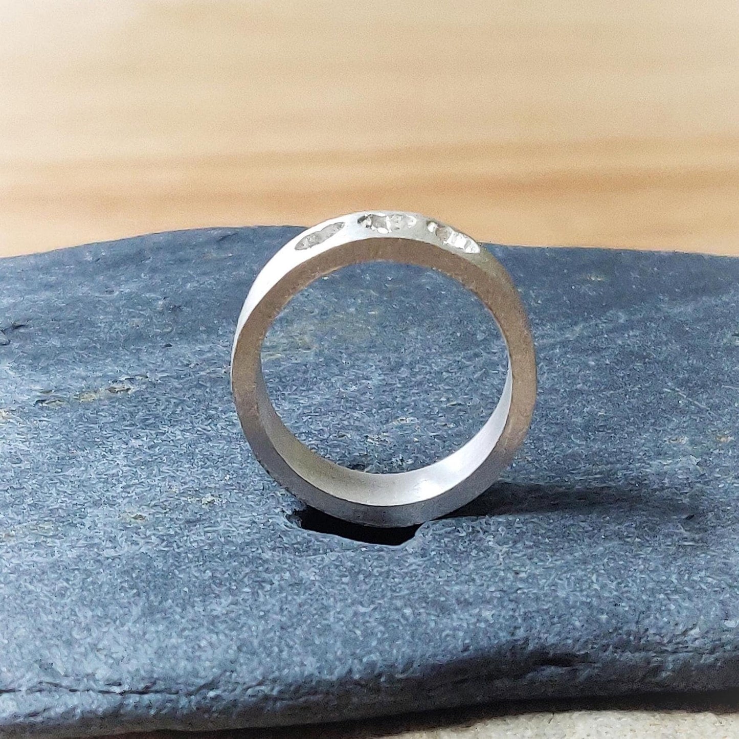 Polished silver band with three heart recesses, designed for keepsake fillings like ashes or breastmilk.