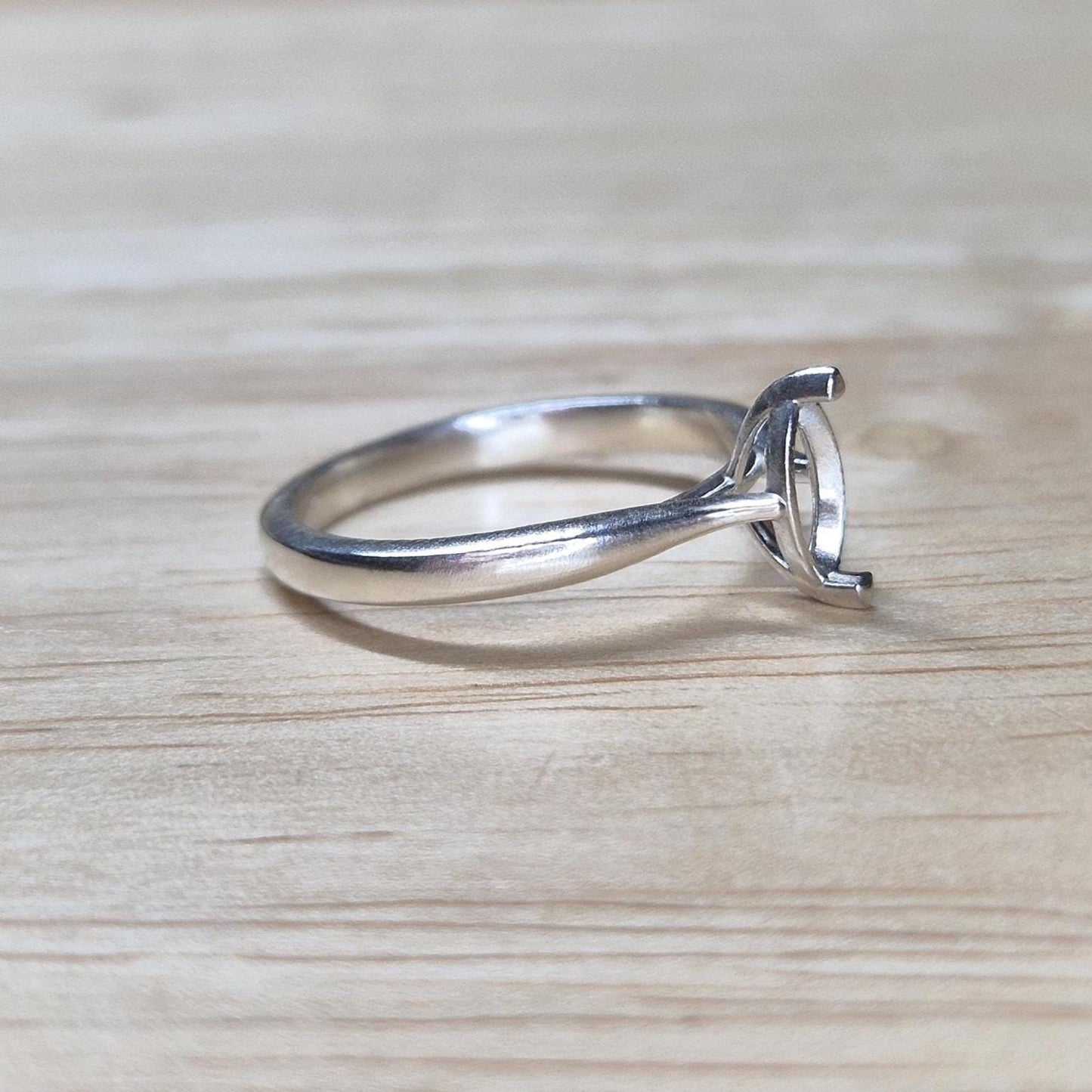 Angled view of an unset silver ring with open 2-prong marquise setting, perfect for DIY jewelers and stone setters.