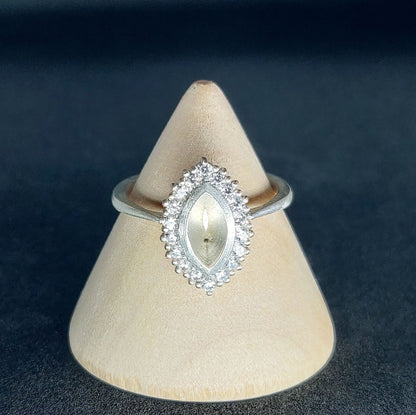 Bezel Set Cluster Marquise Semi Mount Cluster Multistone Silver Ring on a Wooden Cone.