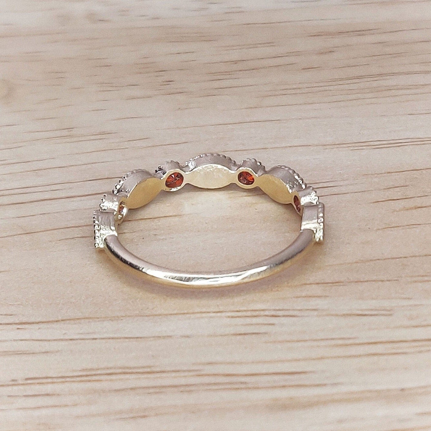 Gold birthstone eternity ring shown from the rear.