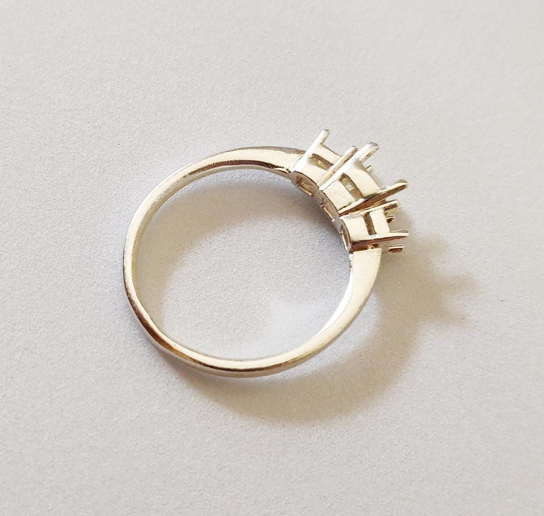 Top view of a 3 stone ring blank in silver for 3 princess cut stones.
