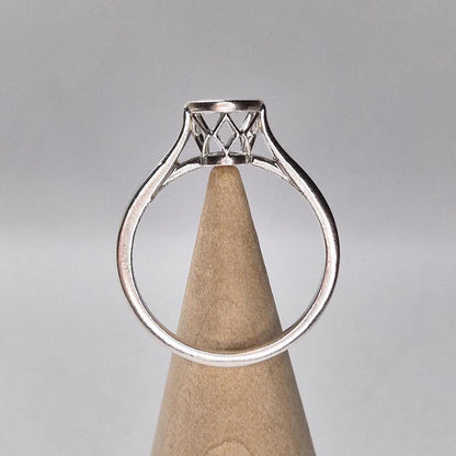 Silver Basket Cathedral Shank Ring on a wooden cone.