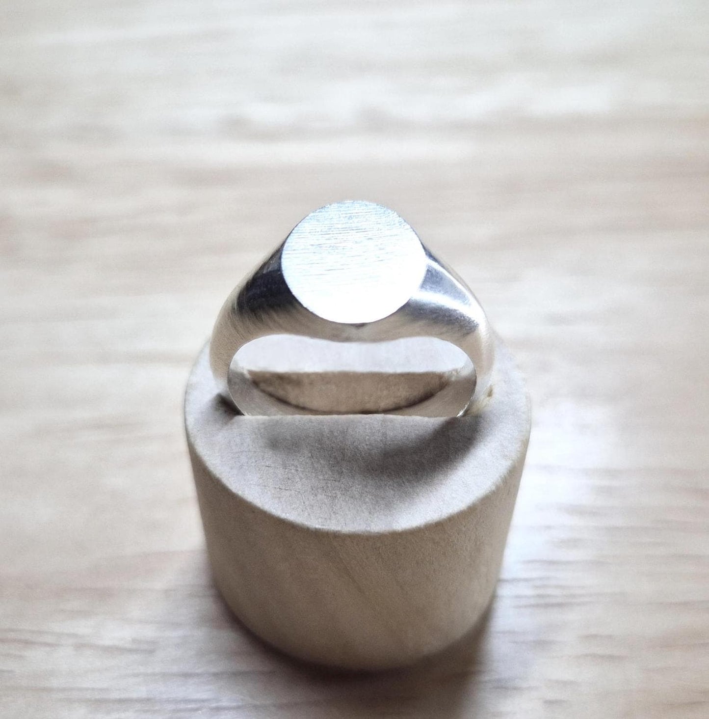 Top view of an oval silver signet ring.