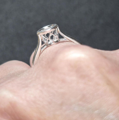 Hand wearing a silver basket bezel ring blank.