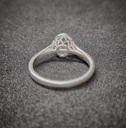 Rear view of a basket silver ring with a cathedral shank.