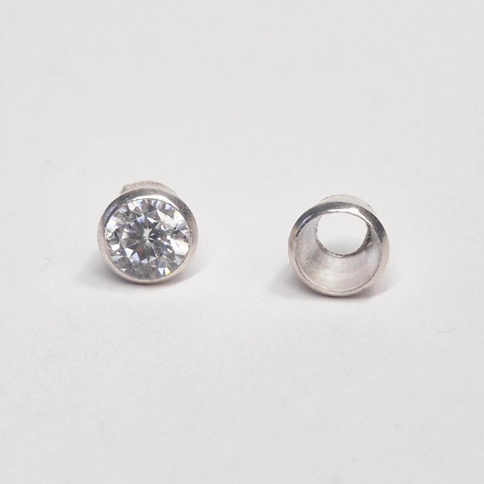 Front and top view of 4mm gemstone and sterling silver bezel cup side by side, highlighting finished and unfinished stages.