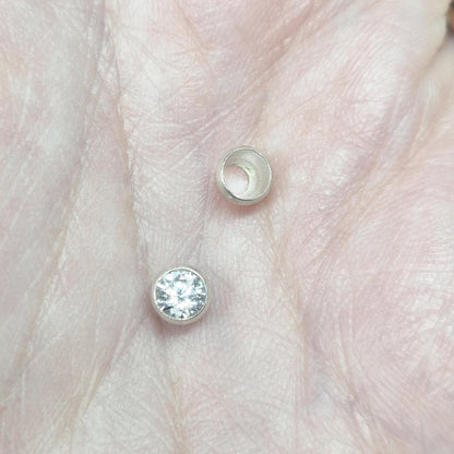 4mm silver bezel cup and gemstone displayed on hand, illustrating size and professional setting quality.