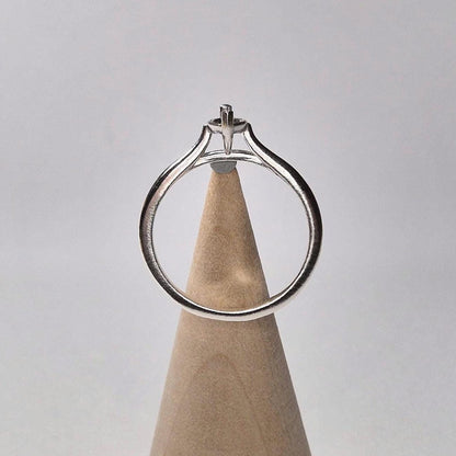 Ring blank standing vertically on a wooden cone, showing the open setting and elegant cathedral arch of the band.