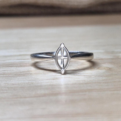 Front-facing shot of a silver ring blank with marquise prongs, ideal for an 8x4mm stone, on a wood backdrop with neutral tones.