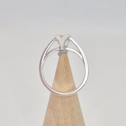 Silver pear cut bezel cathedral ring blank on a conical wooden ring holder, back view, showcasing the back of the pear-shaped bezel setting.