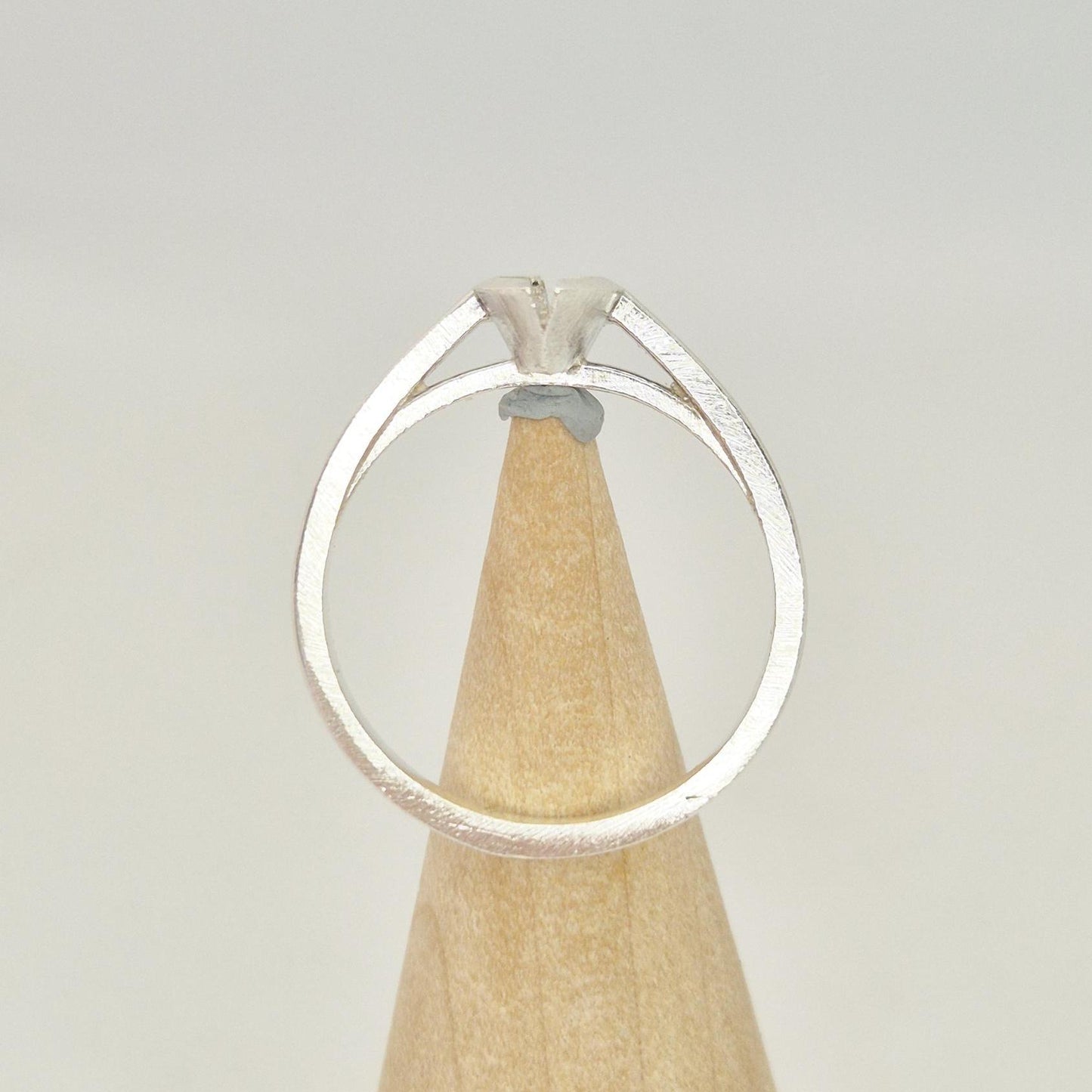 Silver marquise split bezel ring blank on a conical wooden ring holder, viewed from the back, showing the empty marquise-shaped split bezel setting.