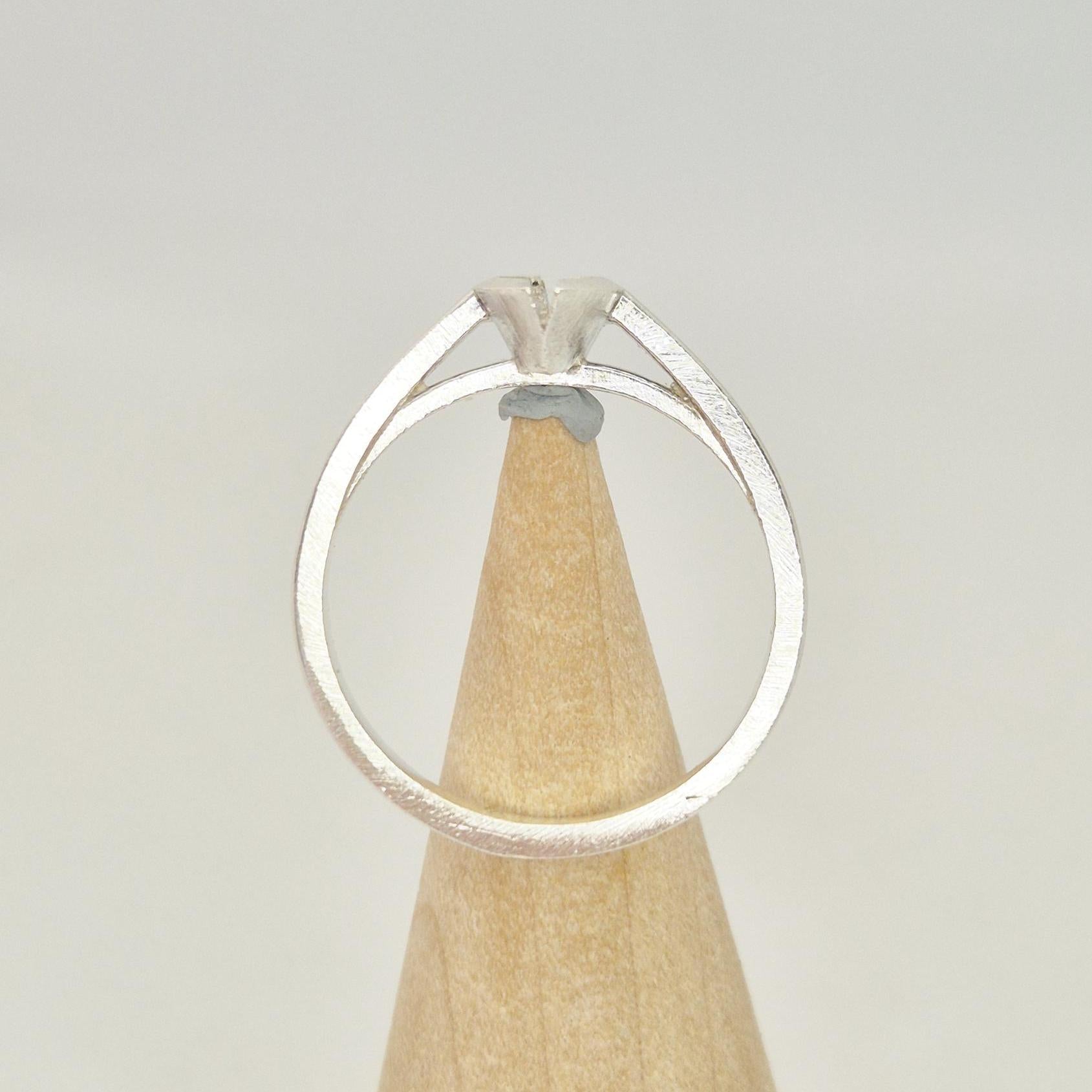Silver marquise split bezel ring blank on a conical wooden ring holder, viewed from the back, showing the empty marquise-shaped split bezel setting.