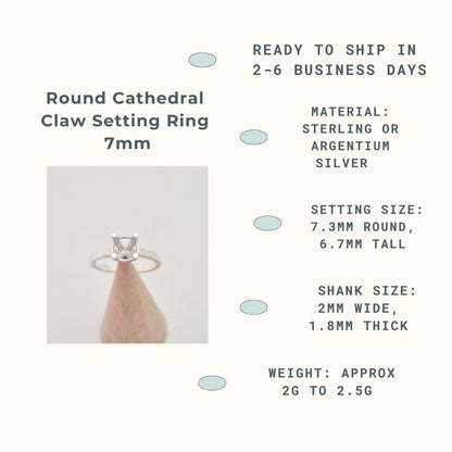 An infographic titled "Round Cathedral Claw Setting Ring 7mm." It features a photo of a silver ring blank with an empty four-prong setting, displayed on a conical wooden holder. The accompanying text provides details: "READY TO SHIP IN 2-6 BUSINESS DAYS," "MATERIAL: STERLING OR ARGENTIUM SILVER," "SETTING SIZE: 7.3MM ROUND, 6.7MM TALL," "SHANK SIZE: 2MM WIDE, 1.8MM THICK," and "WEIGHT: APPROX 2G TO 2.5G