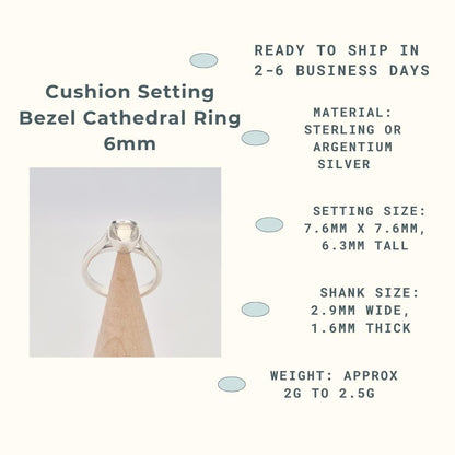 An infographic titled "Cushion Setting Bezel Cathedral Ring 6mm." It features a photo of a silver ring blank with an empty cushion-shaped bezel setting, displayed on a conical wooden holder. The accompanying text provides product specifications: "READY TO SHIP IN 2-6 BUSINESS DAYS," "MATERIAL: STERLING OR ARGENTIUM SILVER," "SETTING SIZE: 7.6MM X 7.6MM, 6.3MM TALL," "SHANK SIZE: 2.9MM WIDE, 1.6MM THICK," and "WEIGHT: APPROX 2G TO 2.5G."