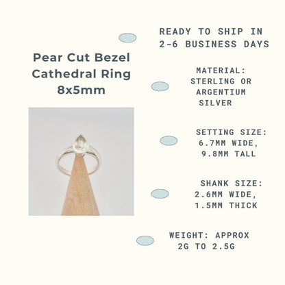 "Infographic for a Pear Cut Bezel Cathedral Ring 8x5mm blank, featuring a silver ring blank on a conical wooden holder with product details: ready to ship in 2-6 business days, sterling or argentium silver material, setting size 6.7mm wide, 9.8mm tall, shank size 2.6mm wide, 1.5mm thick, and approximate weight 2g to 2.5g.