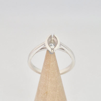 Silver marquise split bezel ring blank on a conical wooden ring holder, viewed from the front, showing the empty marquise-shaped split bezel setting.