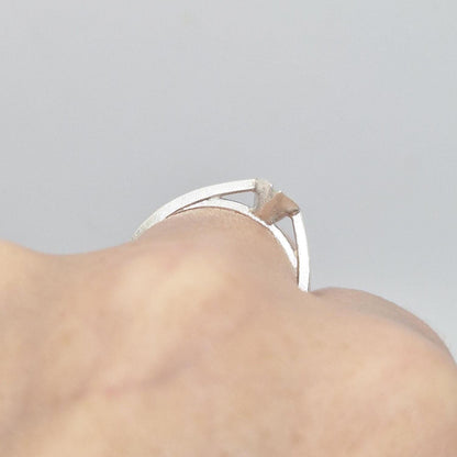 Close-up of a silver marquise split bezel ring blank on a hand, emphasizing the empty marquise-shaped split bezel setting and the ring's design on the finger.