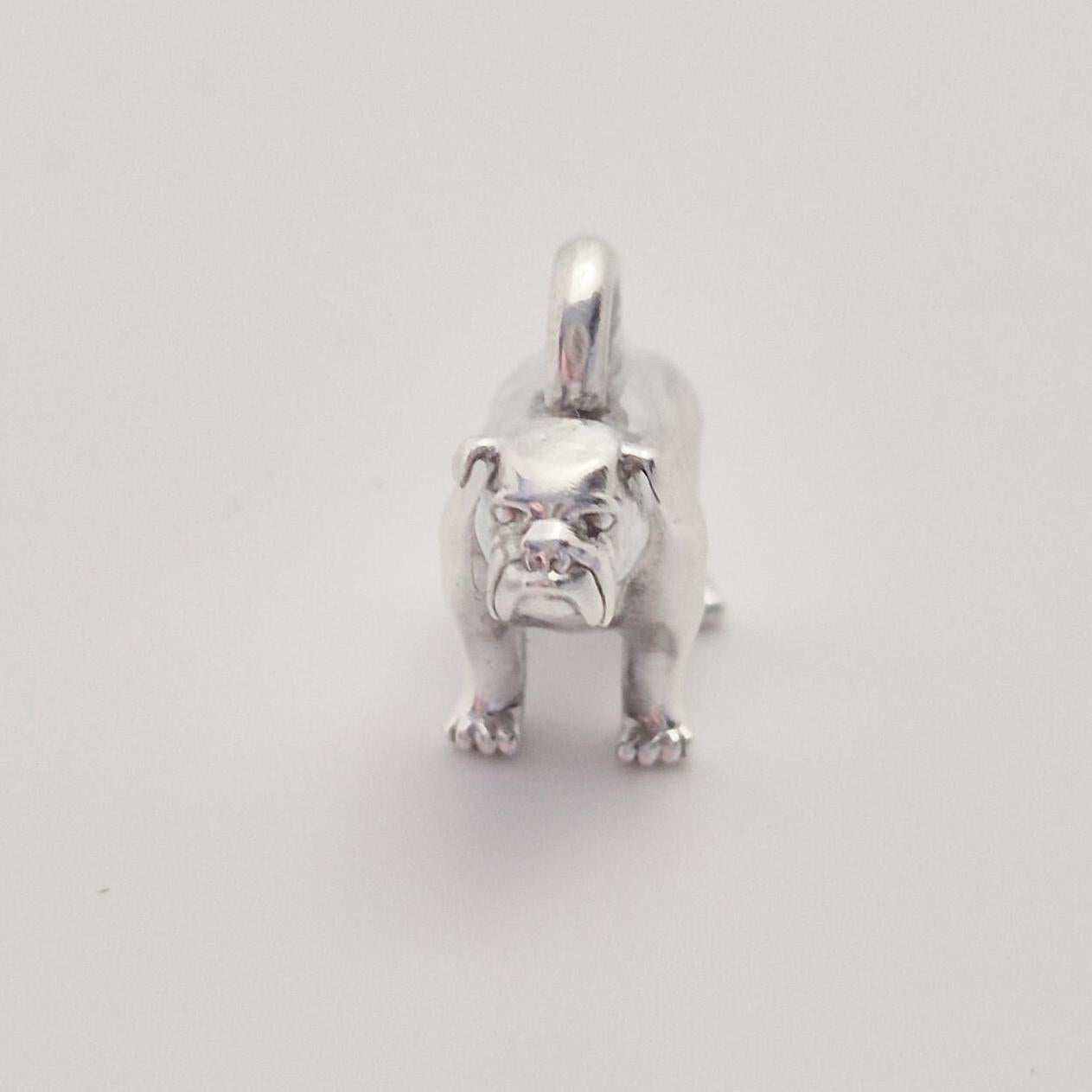 Front-facing view of a silver bulldog charm with top loop, showing the symmetrical stance and detailed paws.