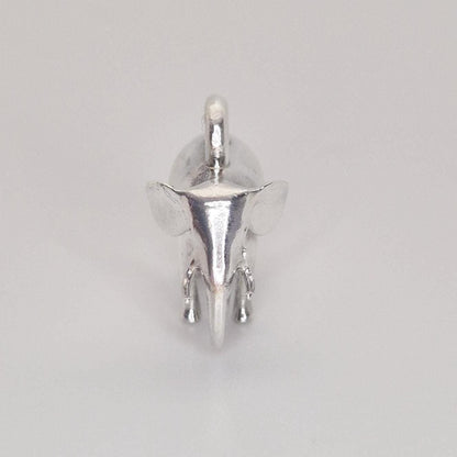 Top-down view of a polished silver elephant charm on a white background, showing the integrated hanging loop and head detail.