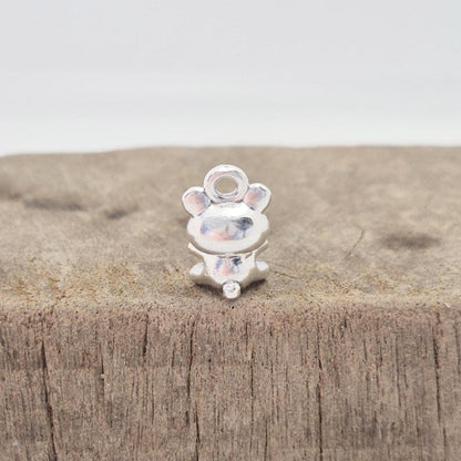 Rear detail of silver teddy bear charm showing compact seated design