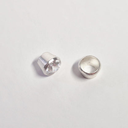 Side view comparison of gemstone set in sterling silver bezel and empty bezel cup for jewellery making.