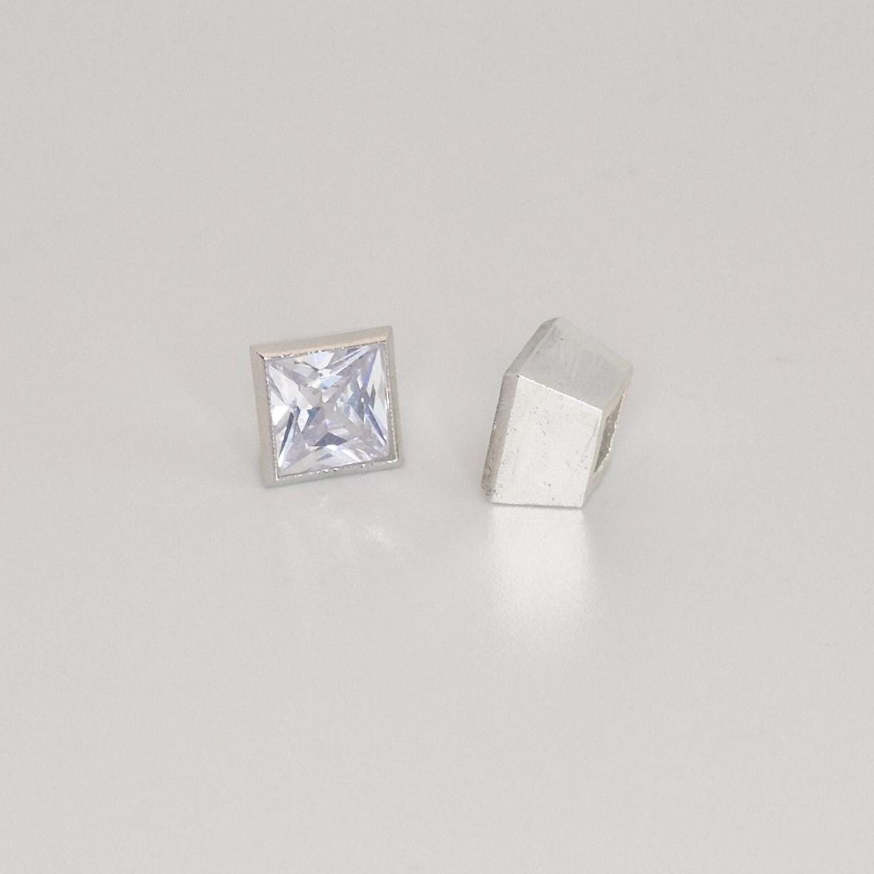 7mm princess cut square bezel setting in sterling silver with gemstone shown beside unfinished setting component.