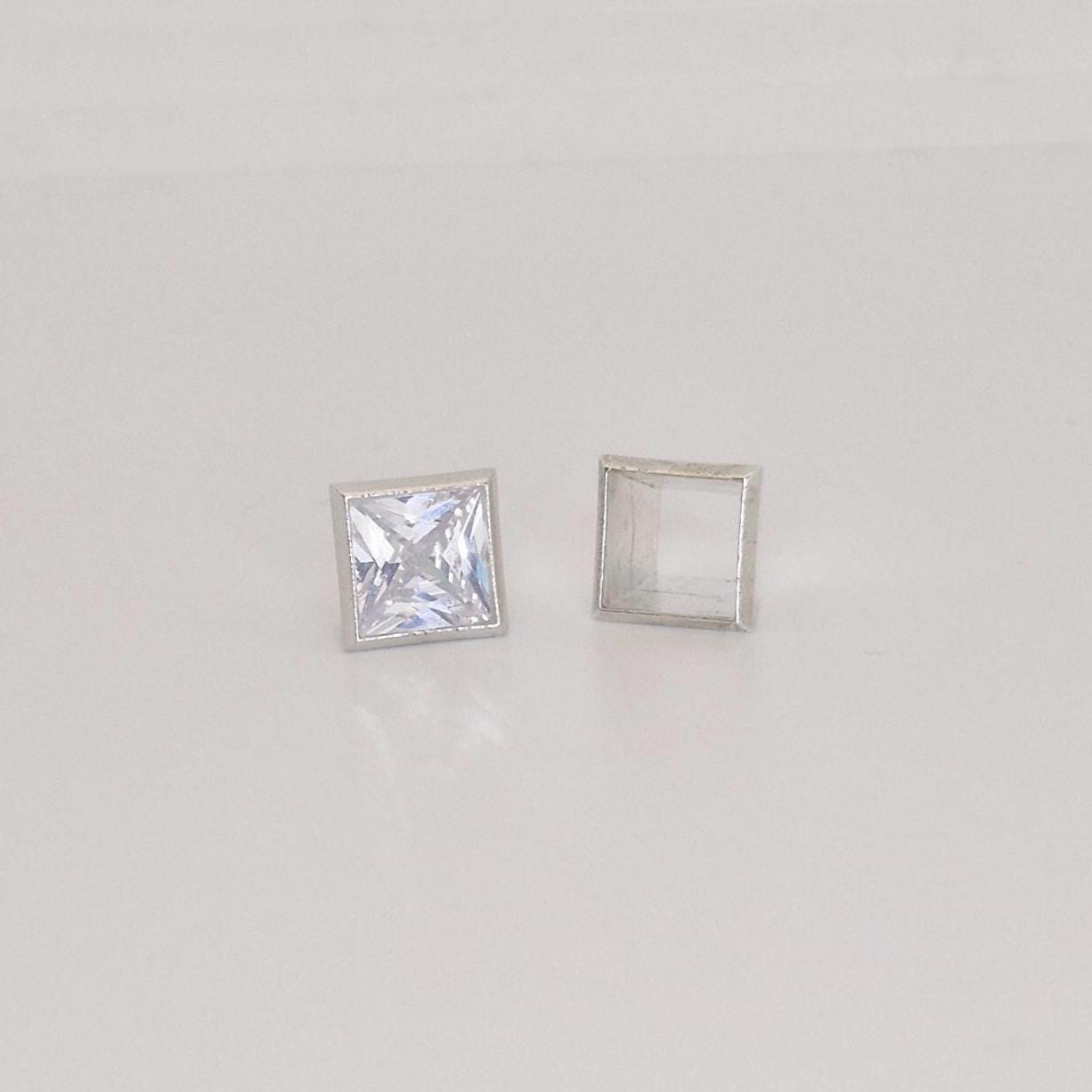 7mm square bezel setting in sterling silver with princess cut stone and empty setting frame.