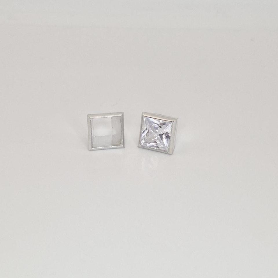 8mm princess cut square bezel setting in sterling silver with gemstone beside empty setting.