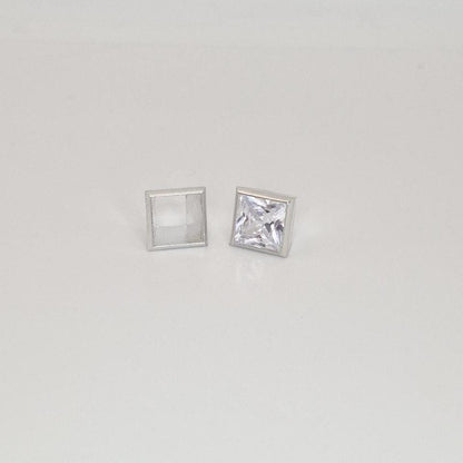 8mm princess cut square bezel setting in sterling silver with gemstone beside empty setting.