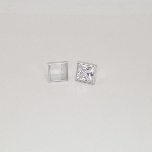 8mm princess cut square bezel setting in sterling silver with gemstone beside empty setting.