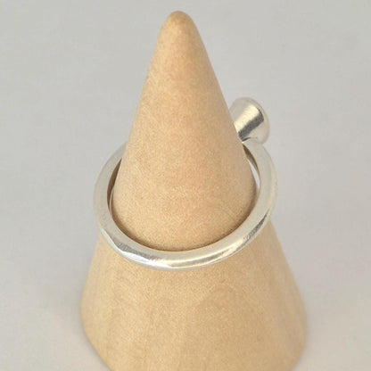 Side view of a 6x4mm Oval Bezel Ring on a wooden cone.