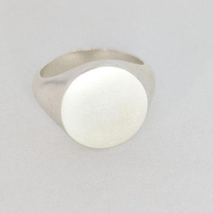 Front view of 16mm round signet ring blank, smooth matte top ready for engraving