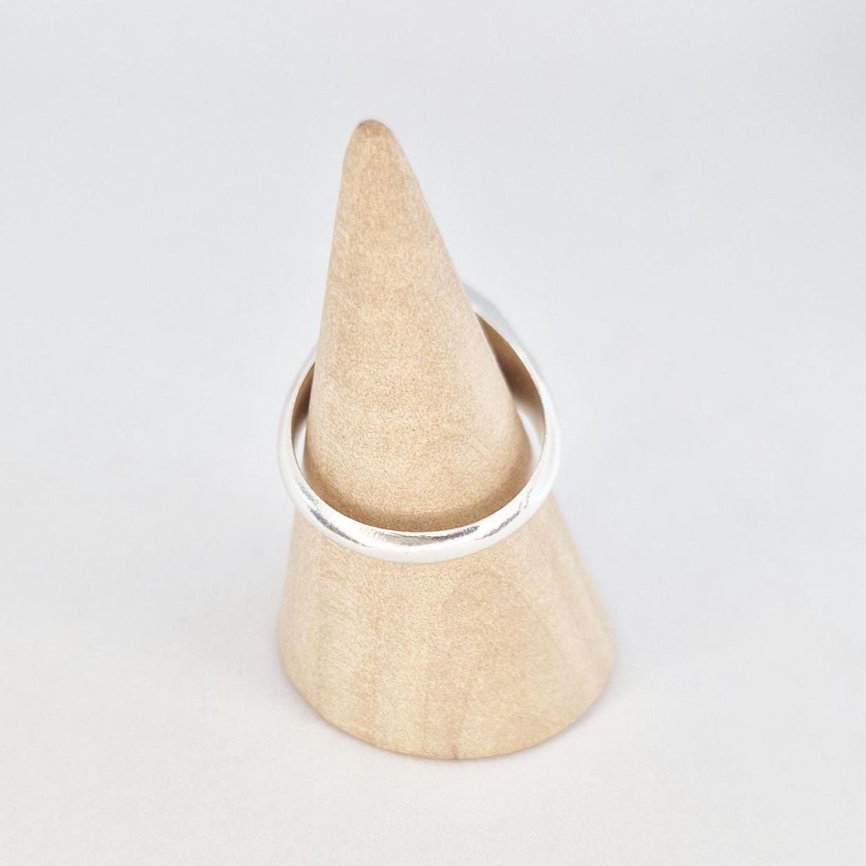 Octagon signet ring blank displayed on wooden ring mandrel, flat face ready for engraving or stone setting