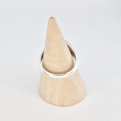 Octagon signet ring blank displayed on wooden ring mandrel, flat face ready for engraving or stone setting