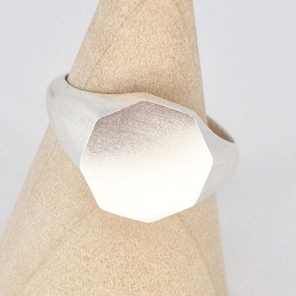 Close-up of octagonal signet ring face showing smooth flat surface ideal for engraving or customisation