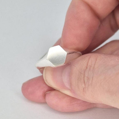 Sterling silver hexagon signet ring side profile showing tapered shoulders and matte hex face