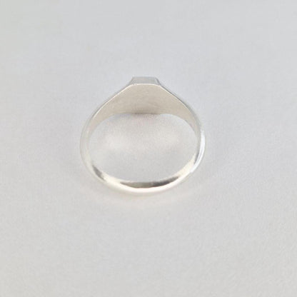 Front view of sterling silver hexagon signet ring with flat hexagonal face and polished shank
