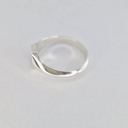 Side view of minimalist silver signet ring with hexagon top and smooth curved band