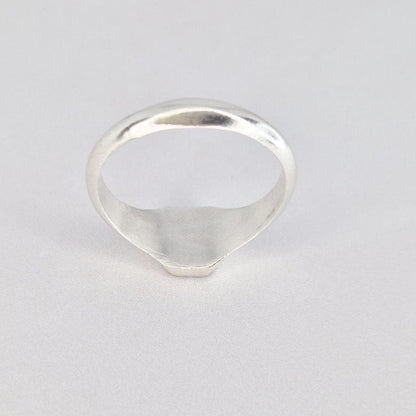 Back view of silver signet ring showing rounded band and smooth interior finish