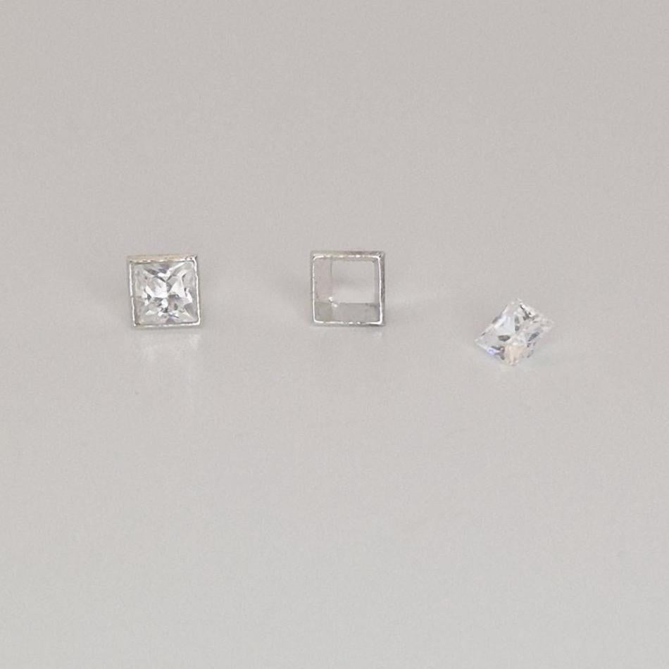 Close-up comparison of set and unset square bezel settings with princess-cut gemstones